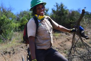 Youth corps member removing fire fuel