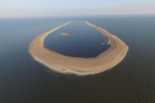 This sand berm built around the eroded remains of a barrier island off Mississippi’s coast will be filled with 3 million cubic yards of sand